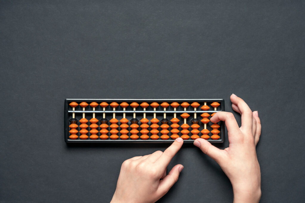 Сhild counting on soroban abacus. black background with copy space. concept education, school arithmetic, calculating thinking